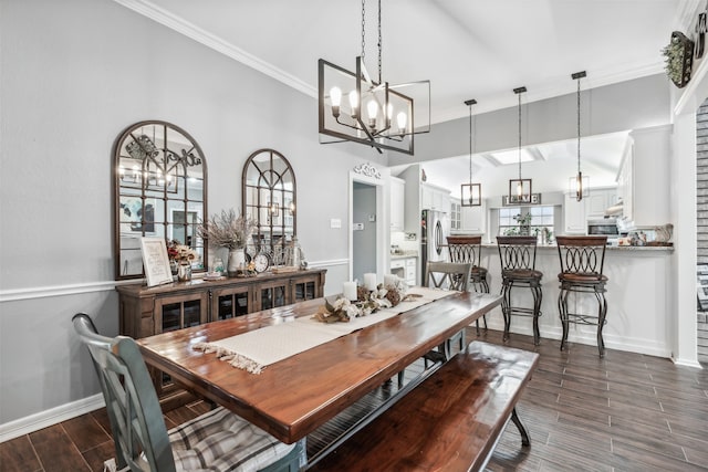 dining space featuring a notable chandelier, crown molding, and a towering ceiling