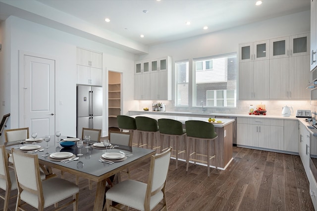 dining room with dark hardwood / wood-style floors and sink