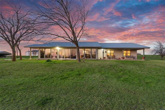 view of front of home with a lawn