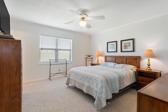 bedroom featuring carpet floors, a textured ceiling, ornamental molding, and a ceiling fan