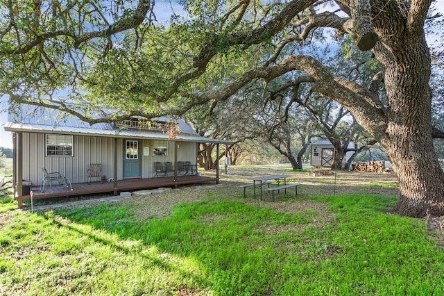 view of yard with an outbuilding and a wooden deck