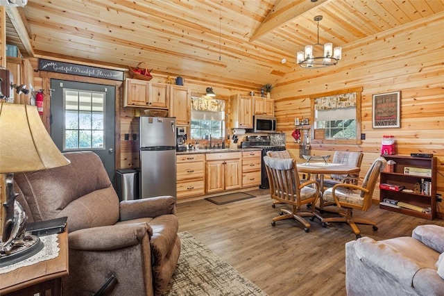 kitchen with lofted ceiling, wood finished floors, wood ceiling, appliances with stainless steel finishes, and light brown cabinetry