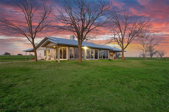 ranch-style house featuring a lawn