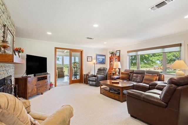 carpeted living room featuring french doors, a fireplace, visible vents, and recessed lighting