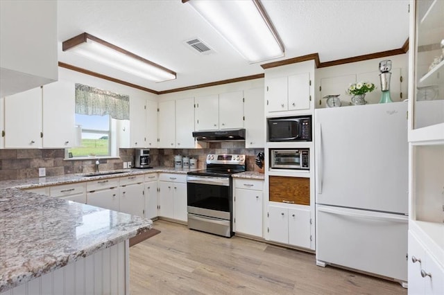 kitchen with under cabinet range hood, a sink, white cabinetry, appliances with stainless steel finishes, and light wood-type flooring