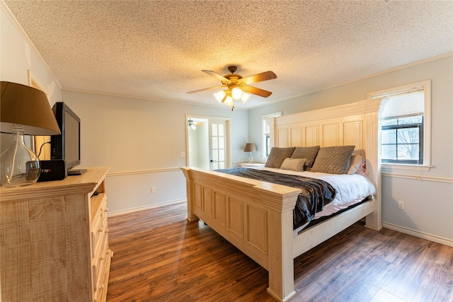 bedroom featuring crown molding, dark wood-type flooring, and a textured ceiling