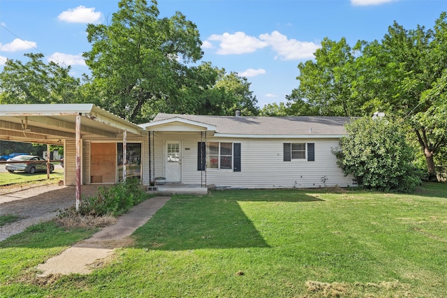 ranch-style home featuring a carport and a front yard