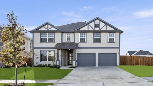 view of front of home with a front lawn and a garage