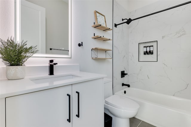 full bathroom with tiled shower / bath, vanity, and toilet