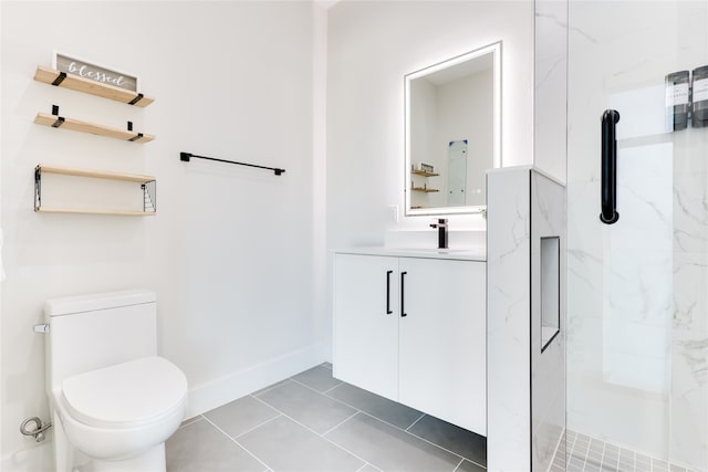 bathroom with a tile shower, vanity, toilet, and tile patterned floors