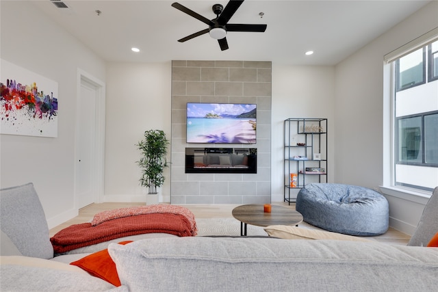 living room with ceiling fan and hardwood / wood-style floors