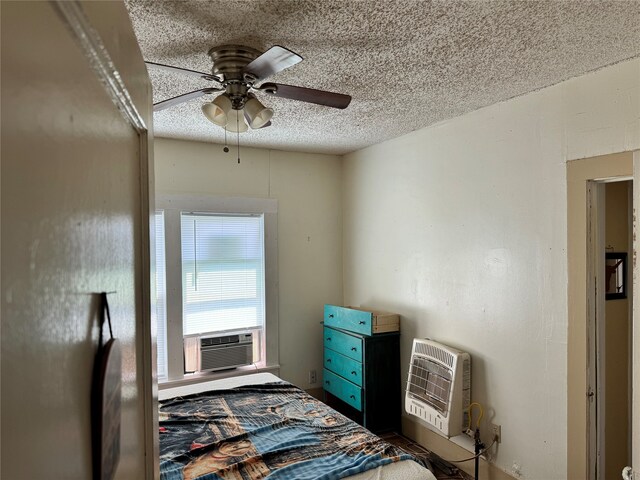 bedroom with cooling unit, a textured ceiling, and ceiling fan