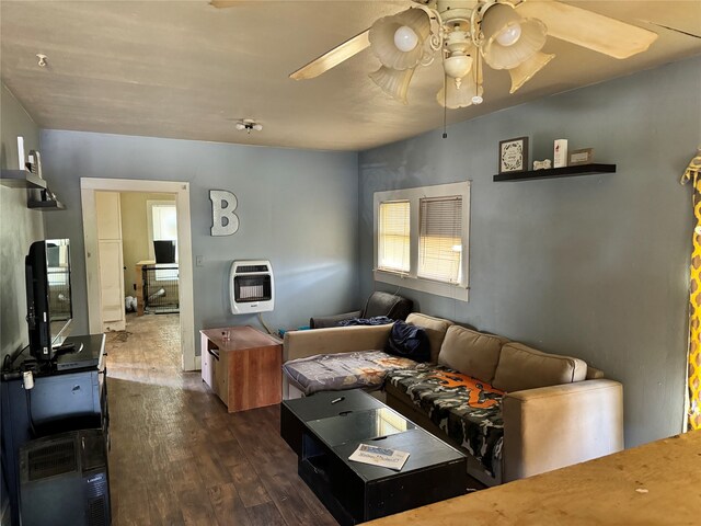 living room with dark hardwood / wood-style flooring and ceiling fan