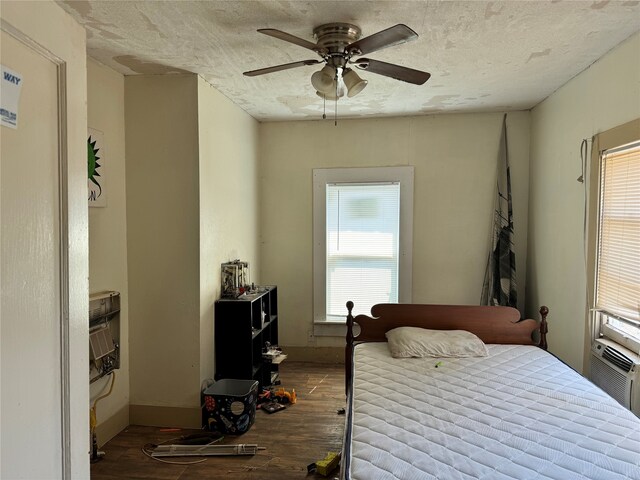 bedroom featuring hardwood / wood-style flooring, multiple windows, and ceiling fan