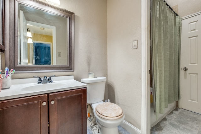 bathroom featuring tile patterned flooring, toilet, and vanity