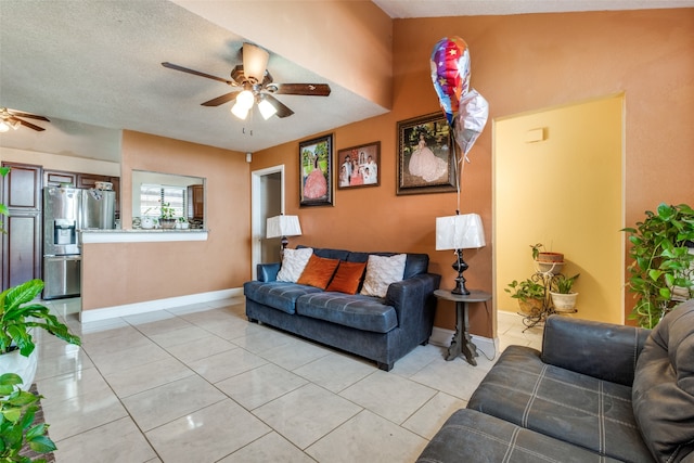 tiled living room with a textured ceiling and ceiling fan