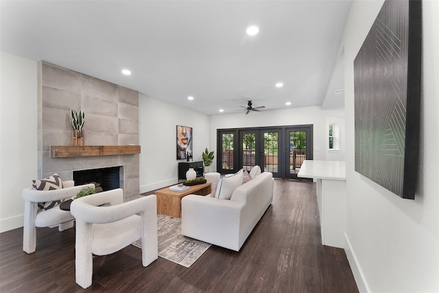 living room featuring french doors, ceiling fan, dark hardwood / wood-style flooring, and a tiled fireplace