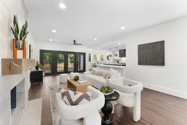 living room with ceiling fan, french doors, and wood-type flooring