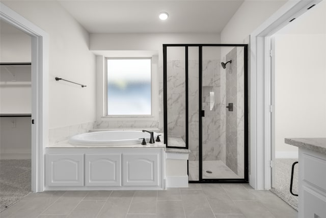 bathroom with tile patterned flooring, vanity, and independent shower and bath