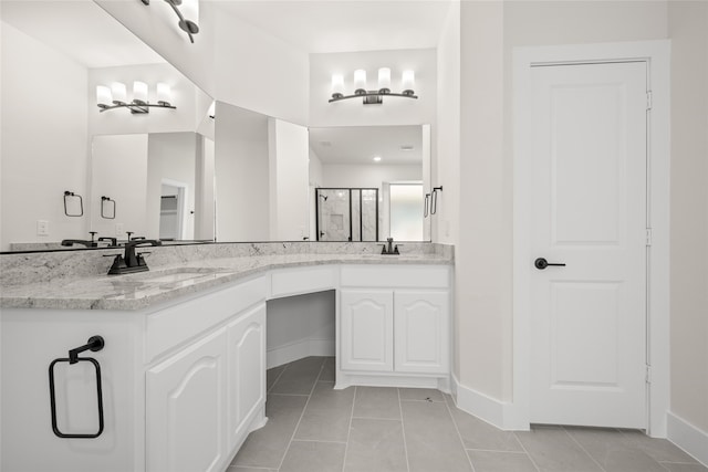 bathroom with vanity, tile patterned floors, an enclosed shower, and a notable chandelier