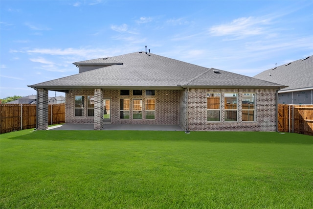 rear view of property with a patio area and a yard