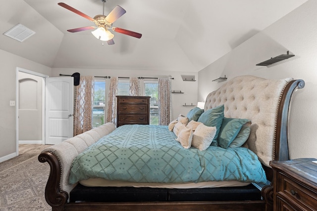 carpeted bedroom with baseboards, visible vents, vaulted ceiling, and a ceiling fan