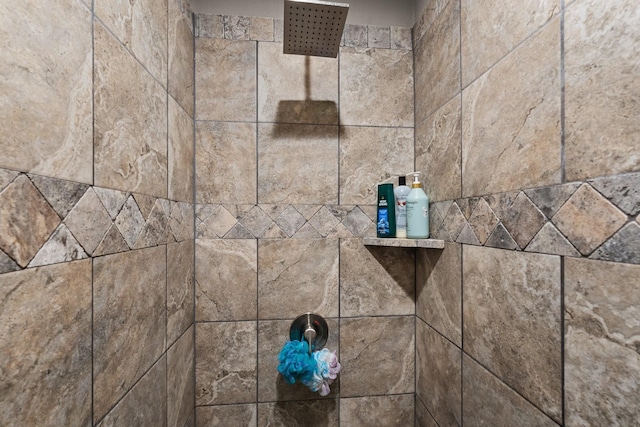 interior details with a tile shower