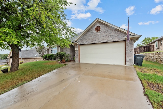 view of front of home with a garage and a front lawn