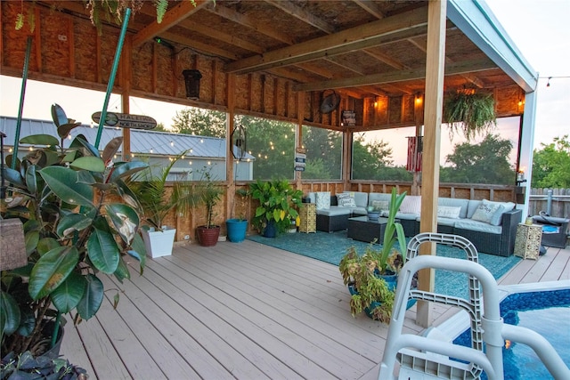 wooden deck with an outdoor hangout area, a gazebo, and fence