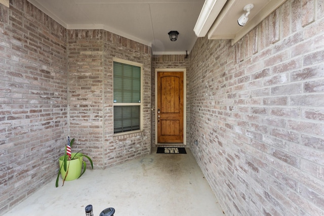 property entrance with brick siding