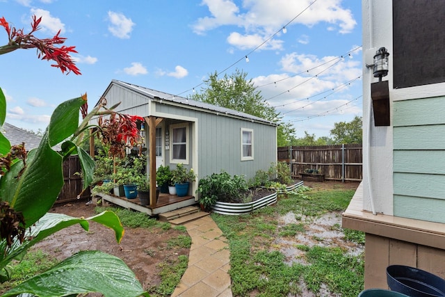 exterior space with fence private yard and an outbuilding