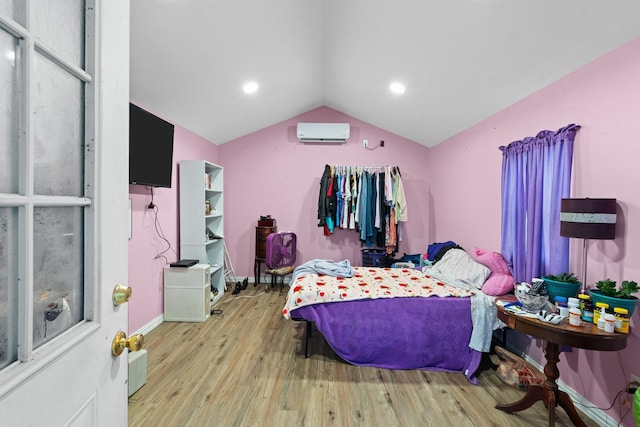 bedroom featuring lofted ceiling, a wall mounted AC, wood finished floors, and recessed lighting