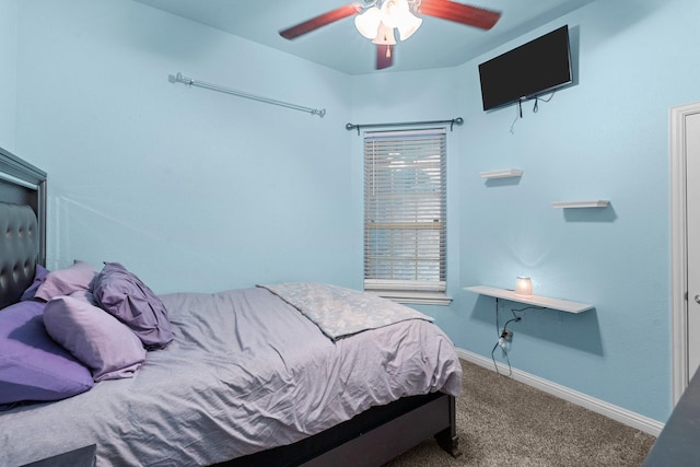 carpeted bedroom with ceiling fan and baseboards