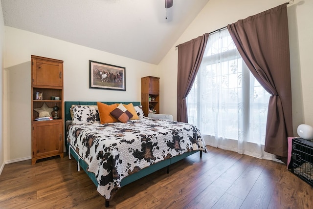 bedroom with ceiling fan, dark hardwood / wood-style flooring, and lofted ceiling