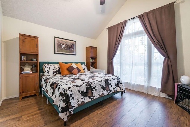 bedroom featuring vaulted ceiling, dark wood-type flooring, and ceiling fan