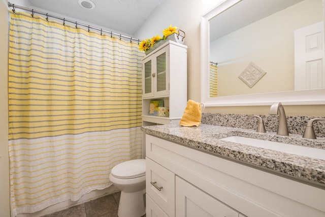 bathroom featuring tile patterned floors, walk in shower, vanity, and toilet