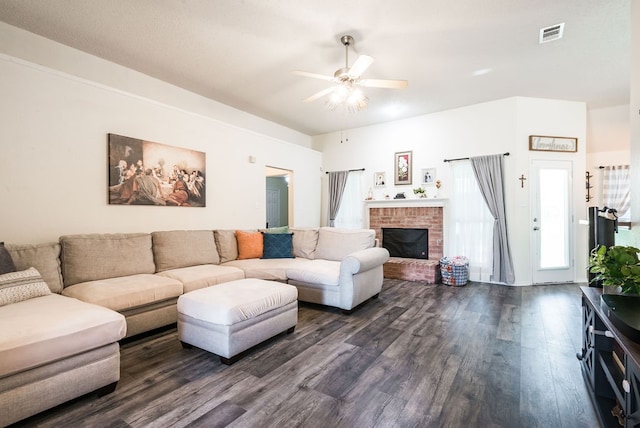 living room with ceiling fan, a fireplace, and dark wood-type flooring