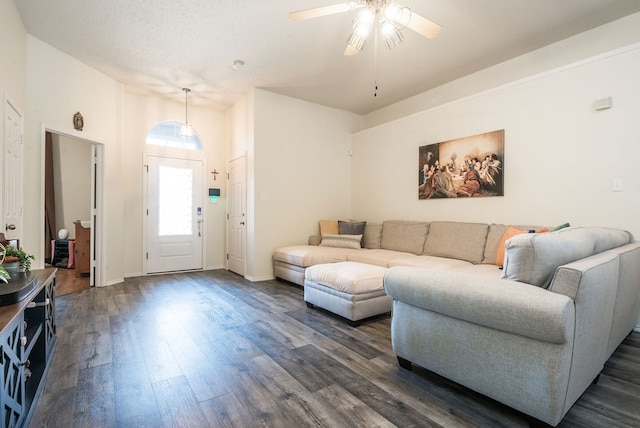 living room featuring ceiling fan and dark wood-type flooring