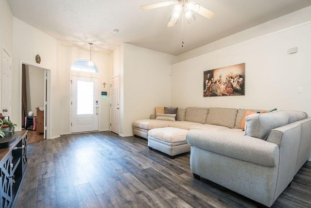 living room with dark wood-style floors, ceiling fan, and baseboards