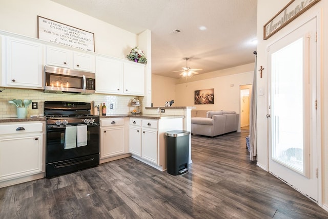 kitchen with kitchen peninsula, tasteful backsplash, black range with gas stovetop, white cabinets, and dark hardwood / wood-style floors