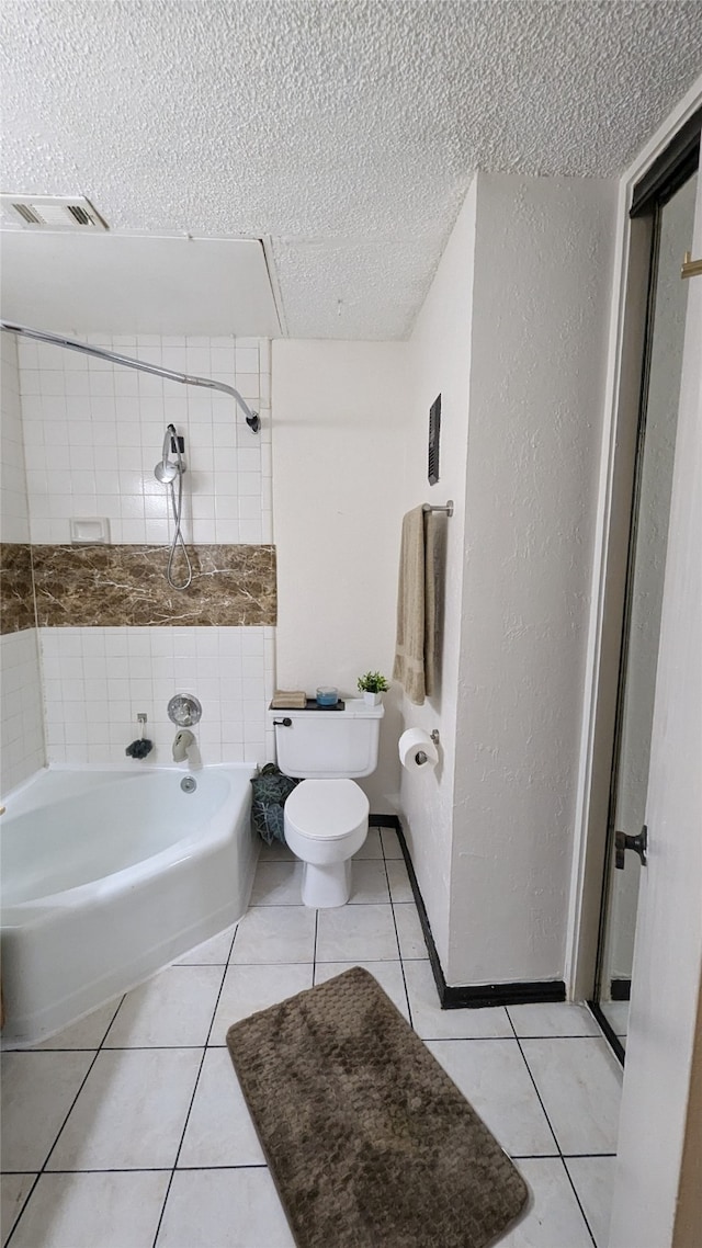 bathroom with toilet, a textured ceiling, tile patterned flooring, and plus walk in shower