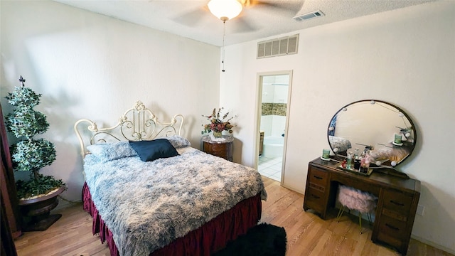 bedroom with connected bathroom, ceiling fan, a textured ceiling, and light hardwood / wood-style floors