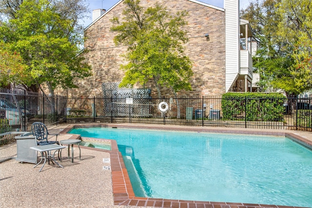 view of pool with an in ground hot tub