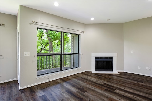 unfurnished living room with dark hardwood / wood-style flooring and a fireplace