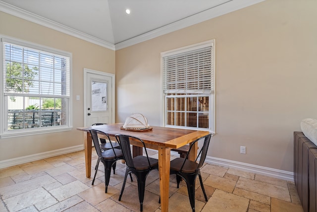 dining space featuring ornamental molding and vaulted ceiling