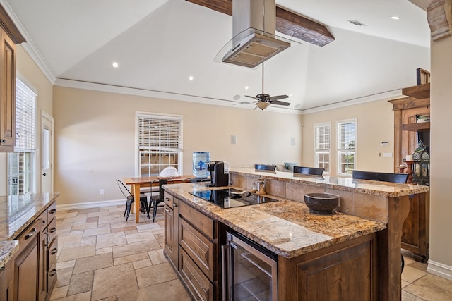 kitchen featuring black electric cooktop, wine cooler, a kitchen island, light stone countertops, and ornamental molding