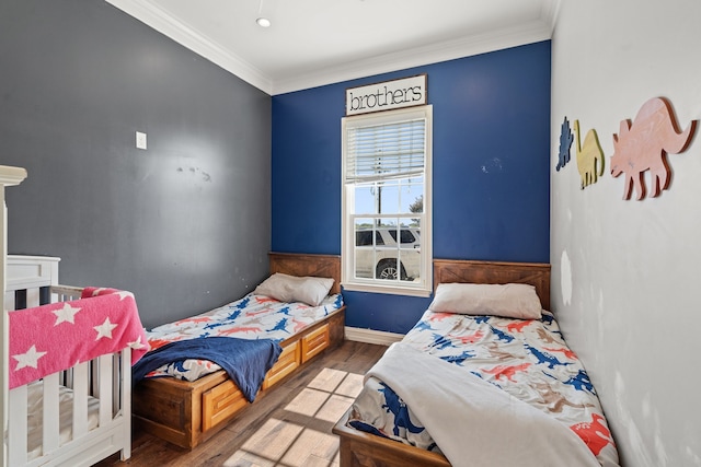 bedroom with wood-type flooring and crown molding