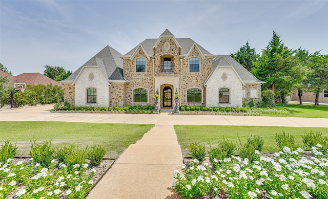 french country style house with a front yard