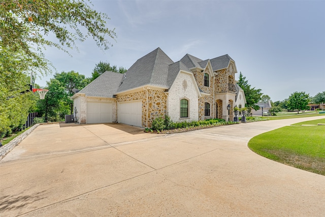 view of home's exterior featuring a garage and a lawn