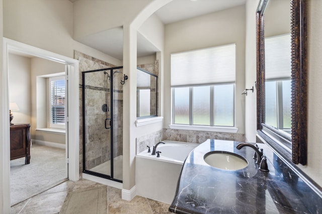 bathroom with separate shower and tub, tile patterned floors, and a wealth of natural light